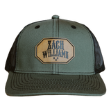 Olive green trucker hat with a ’Zach Williams’ patch on the front.