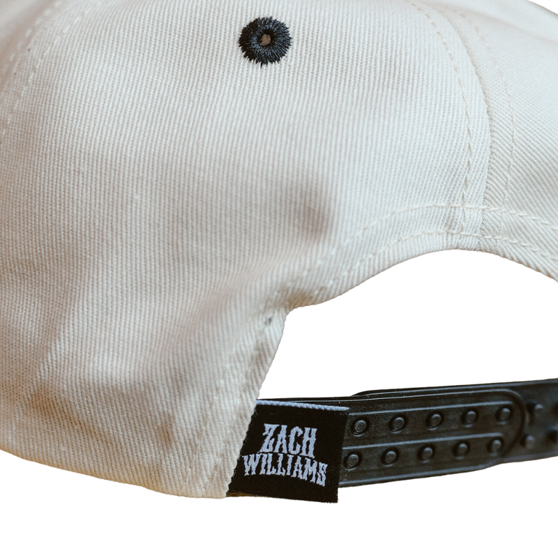 White baseball-style cap with a ’Zach Williams’ branded adjustable strap.