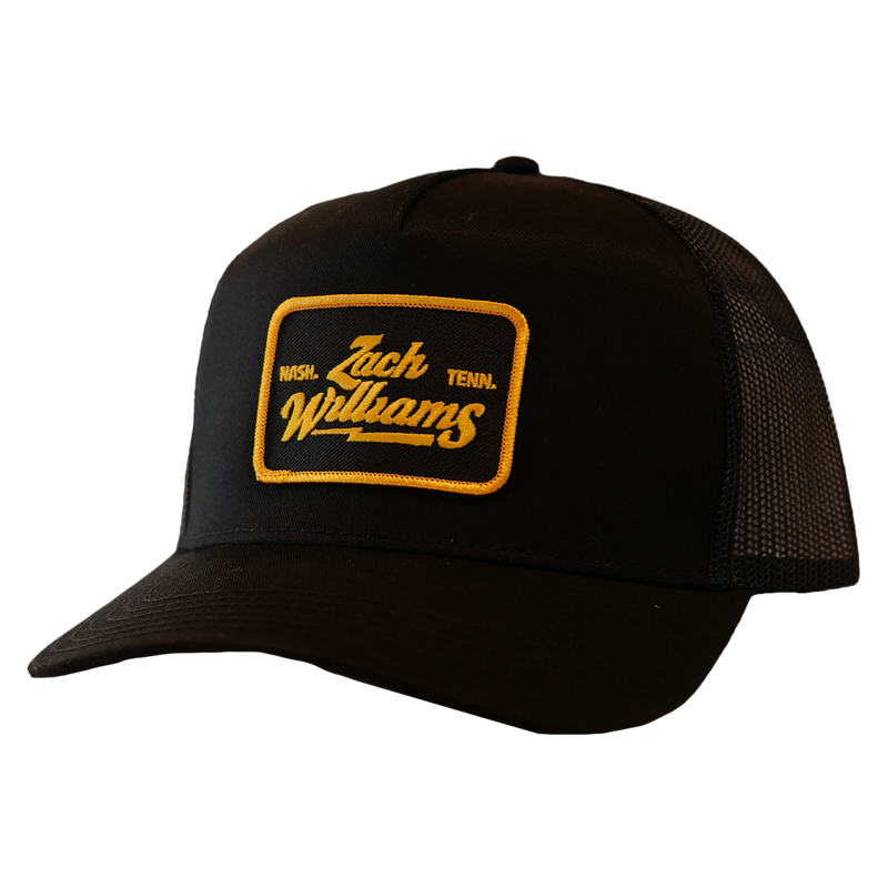 Black trucker hat with a yellow ’Jack Williams’ patch on the front.