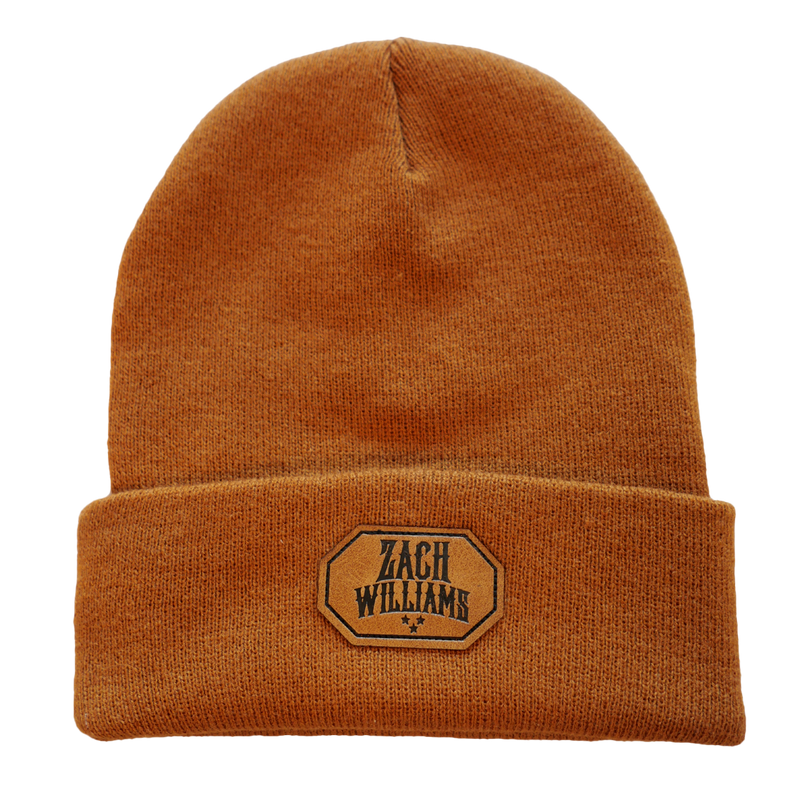 Brown knit beanie with a ’Zach Williams’ logo patch on the folded brim.