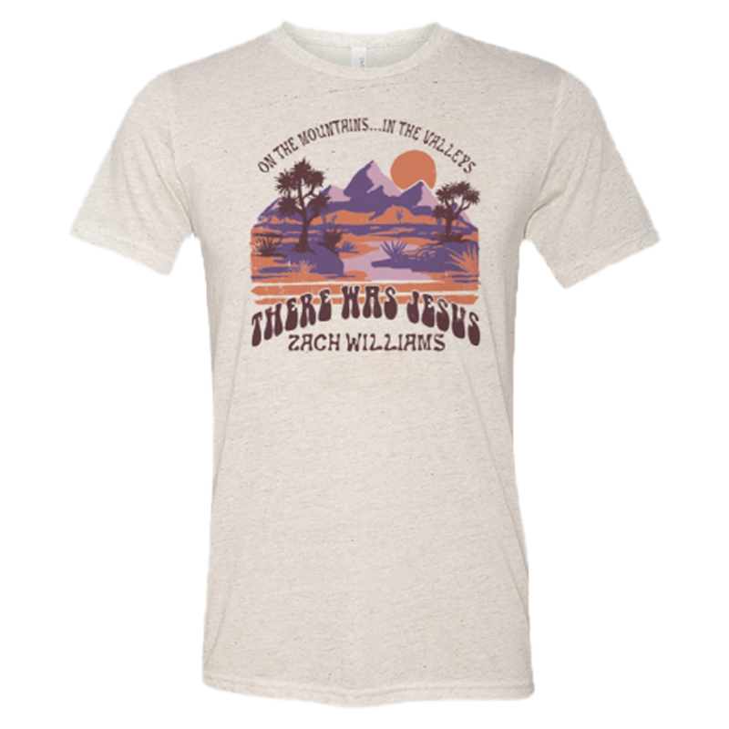 Beige t-shirt with a colorful desert landscape design and text.